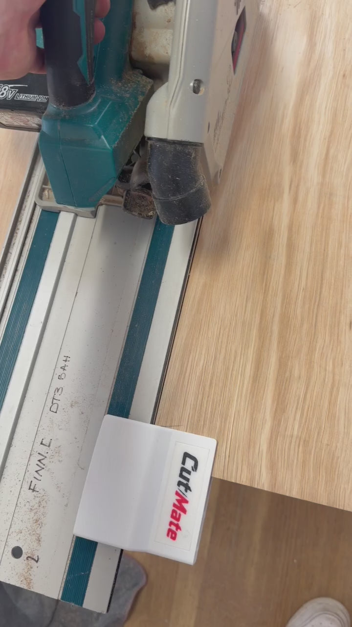 CutMate™ timber support clip holding a board during a track saw cut, with a view from below